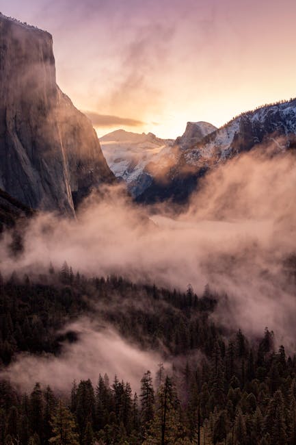 Breathtaking sunrise over Yosemite Valley with mist and stunning mountain views.