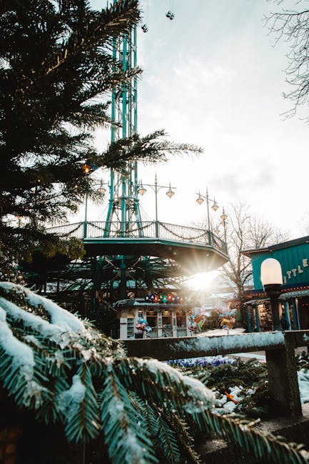 A winter funfair scene featuring snowy decorations and a vibrant sunrise, offering a magical atmosphere.
