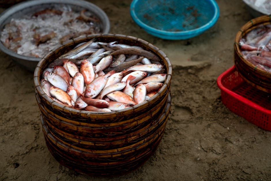 Basket of freshly caught fish on display at an outdoor market with earthy tones.
