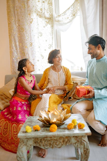A joyful family enjoying Diwali with traditional attire and gift exchange indoors.