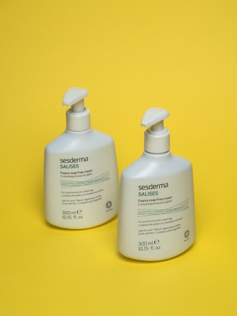 Two Sesderma Salises foamy soap bottles against a vibrant yellow backdrop.