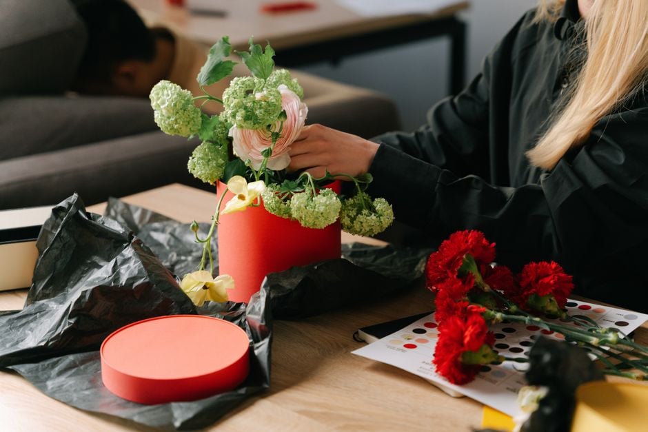 florist arranging subscription box flowers delivery