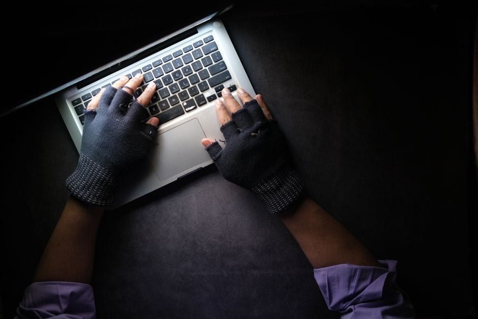 cybersecurity ransomware negotiation chatbot hands on laptop purple light threat actor