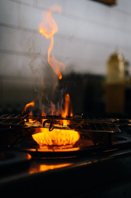 Close-up of a fiery stove with intense flames, showcasing cooking ambiance.