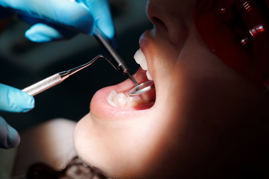 Detailed close-up of a dental check-up with tools and patient under bright light.