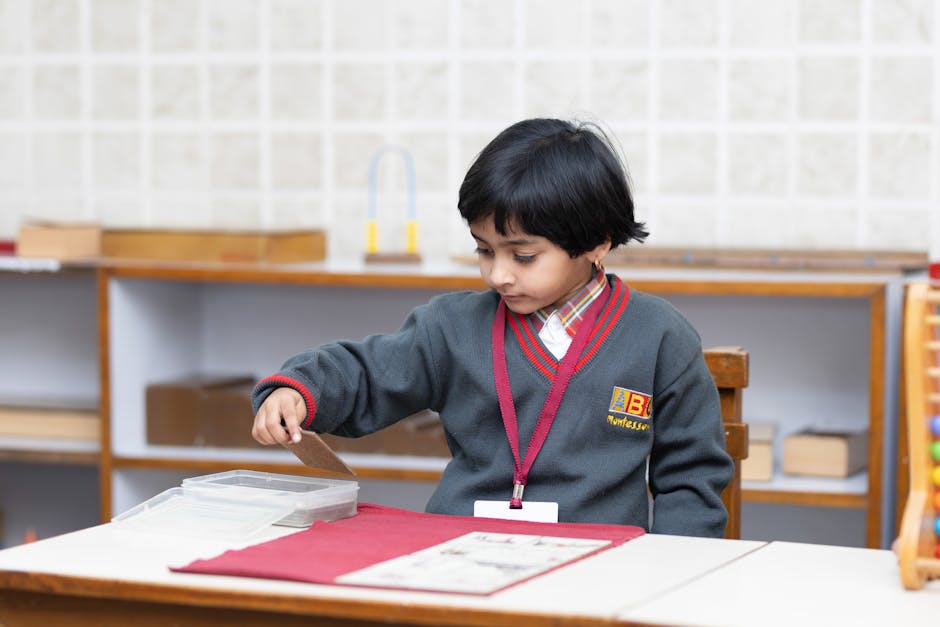 Child engaged in learning activity at a Montessori school, developing fine motor skills.