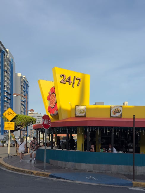 Colorful 24/7 diner in San Juan, Puerto Rico showcasing lively street life and architecture.
