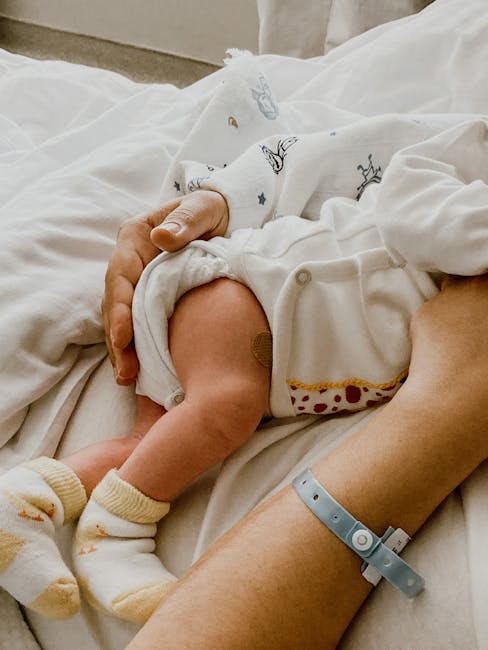 new parent holding newborn hospital bonding parental leave family