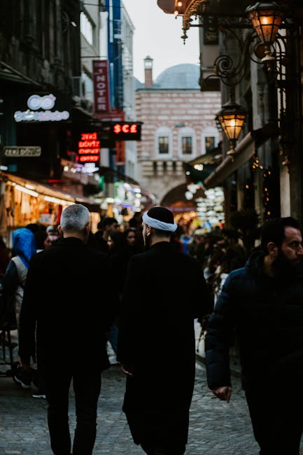 Crowded street in İstanbul with people and vibrant market atmosphere.