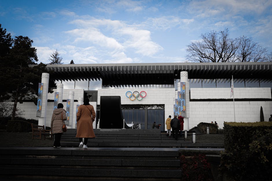 Visitors at the entrance of the Olympic Museum in Lausanne, Switzerland on a clear day.