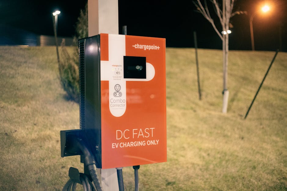 EV DC fast charger station night CCS NACS public charging hub