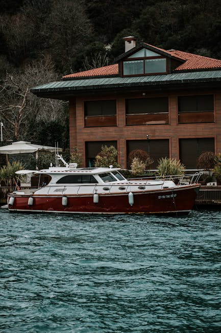 A sleek motorboat docked by a stylish riverside home, exuding tranquility.