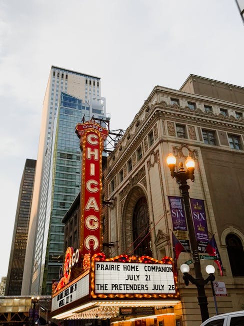 Chicago Theatre marquee with skyscrapers at dusk, vibrant city life.