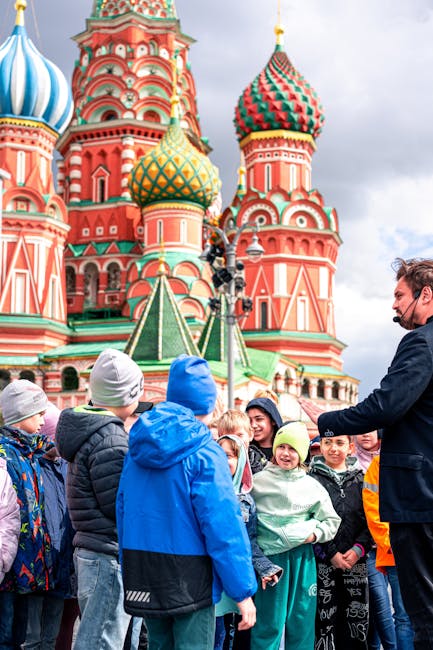 Group of children visiting St. Basil's Cathedral in Moscow, Russia, guided by an adult.