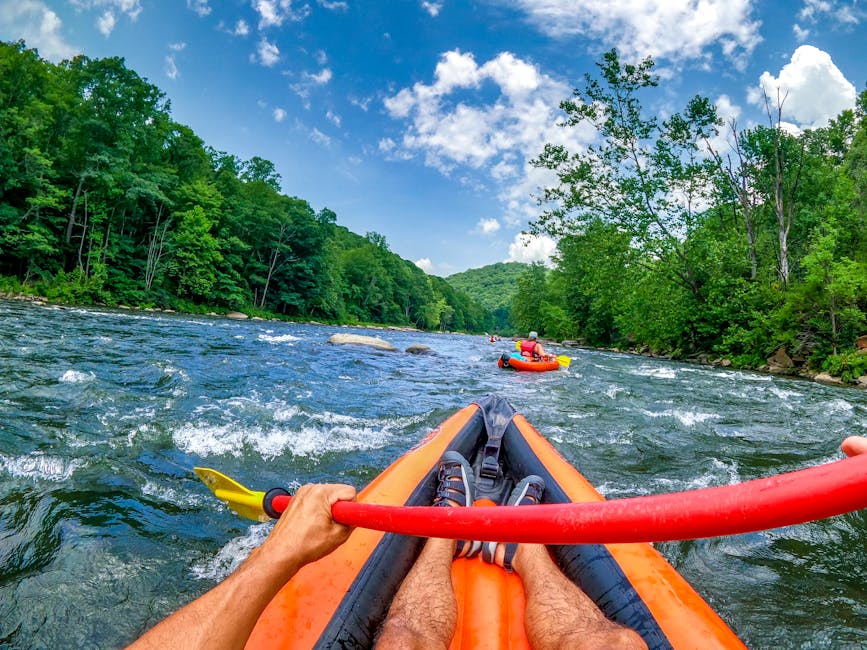 Experience thrilling kayaking on the wild Youghiogheny River in Ohiopyle, PA, with lush green scenery.