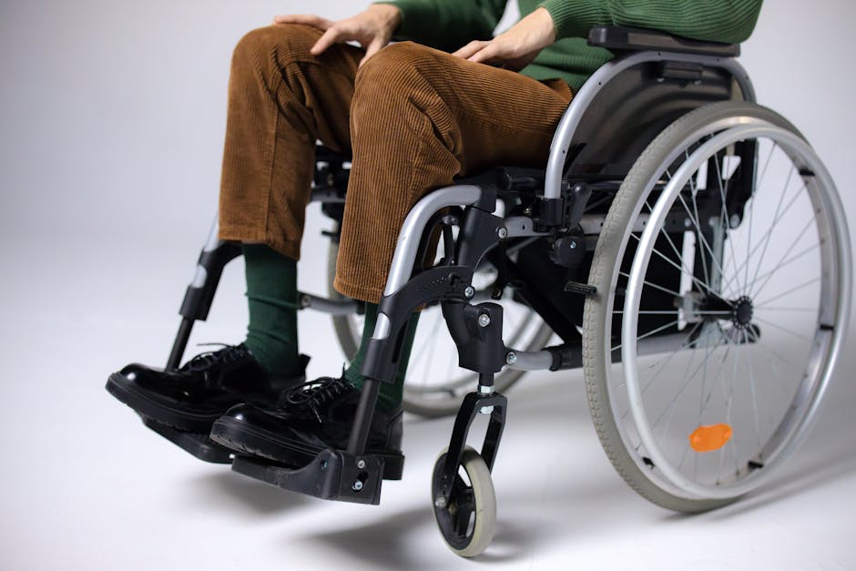 Adult sitting in a wheelchair indoors, focusing on mobility and accessibility.