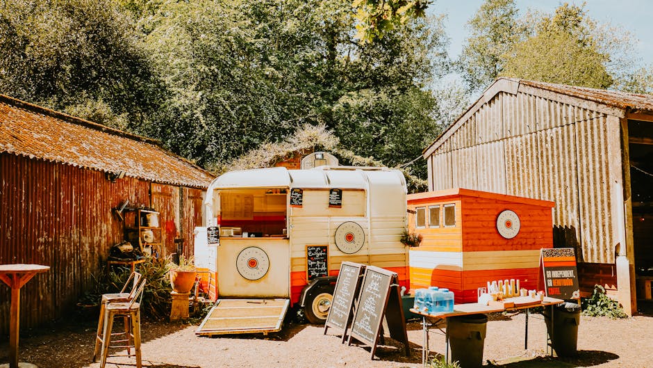 Charming outdoor café featuring a vintage food truck in a rustic setting. Perfect for summer gatherings.