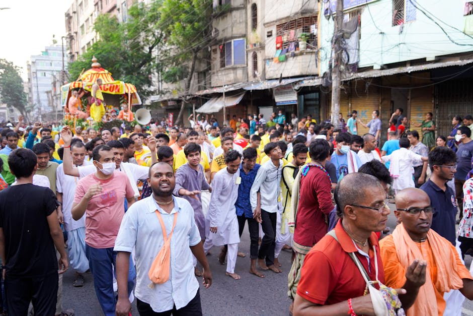 A lively street parade featuring Hindu rituals and celebrations in Dhaka, Bangladesh.