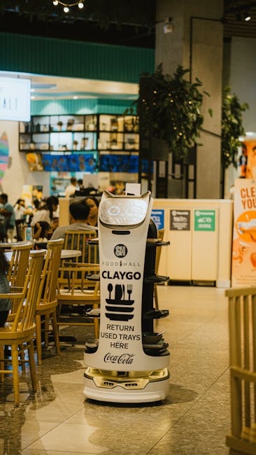 Innovative robot assisting with tray returns in bustling urban food court.