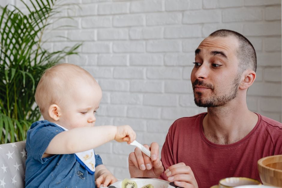 vegan toddler eating lentils tofu with parent