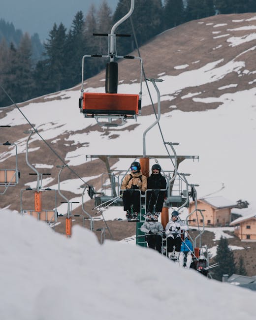 Skiers on a lift in snowy Trentino-Alto Adige, Italy, enjoying a winter day.