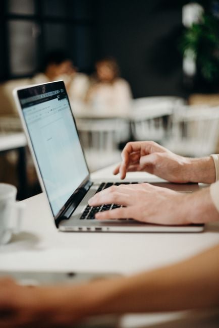 freelancer sending outreach email laptop workspace Middle East