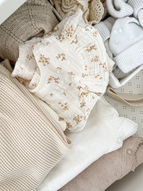 neutral baby clothes flatlay organic cotton pastel onesies romper