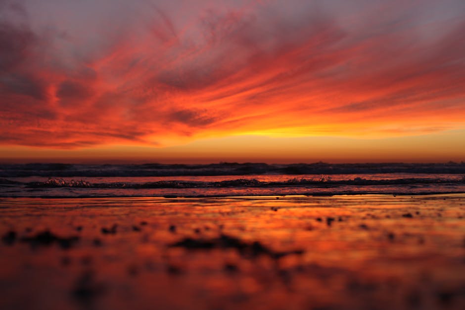Capture the vibrant sunset hues at Huntington Beach, CA, with vivid ocean reflections and serene waves.