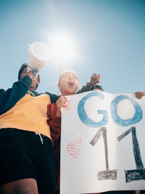 young female footballer scoring celebration crowd 2025