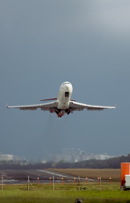 A commercial jet taking off from Bogotá Airport with a dramatic sky background.