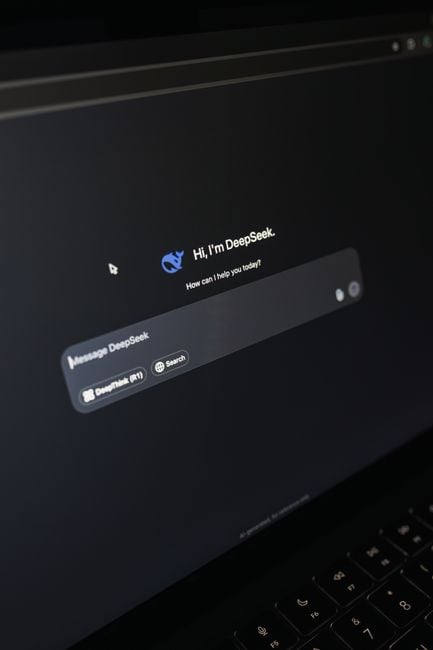 Close-up of a laptop screen displaying an AI chatbot interface with a dark theme.