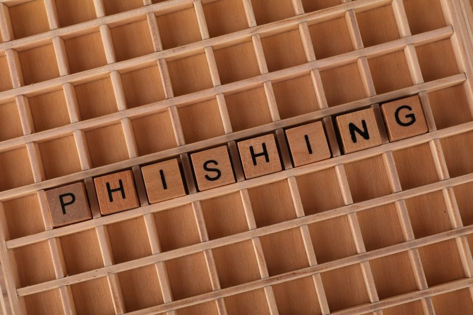 Wooden Scrabble tiles arranged to spell 'Phishing', illustrating online security concepts.