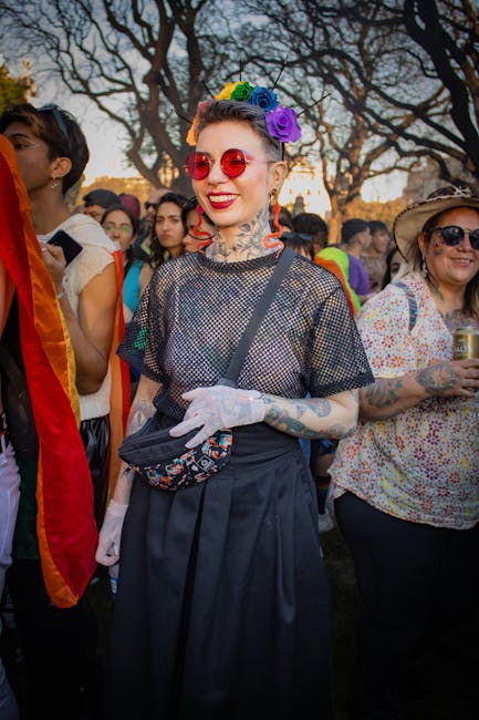 Vibrant scene at a Pride parade with colorful outfits and joyous participants.