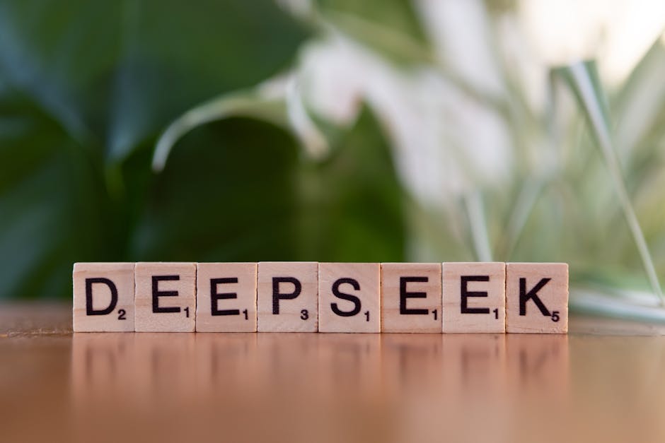 Wooden letter tiles spelling 'DEEPSEEK' on a table with a blurred green background.