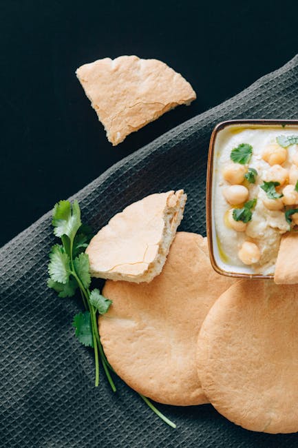 assorted falafel balls on pita with tahini and herbs top view