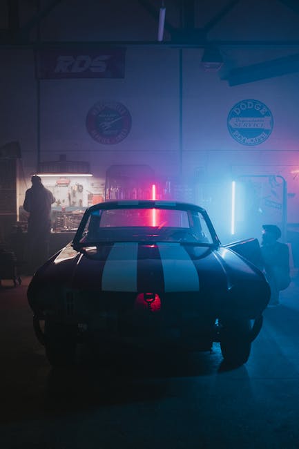 mechanic servicing electric car in modern workshop