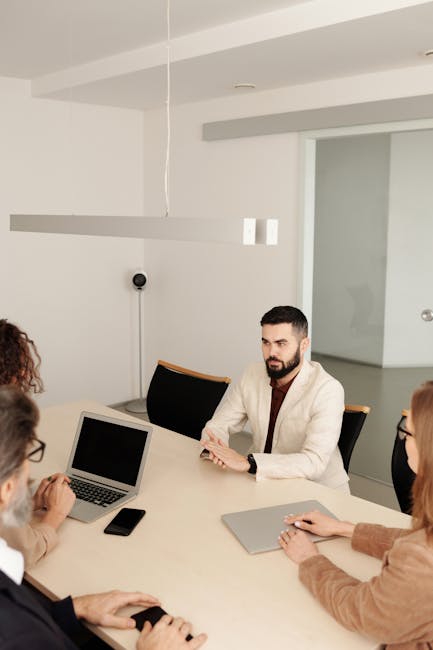 diverse HR team analyzing AI hiring metrics dashboard office