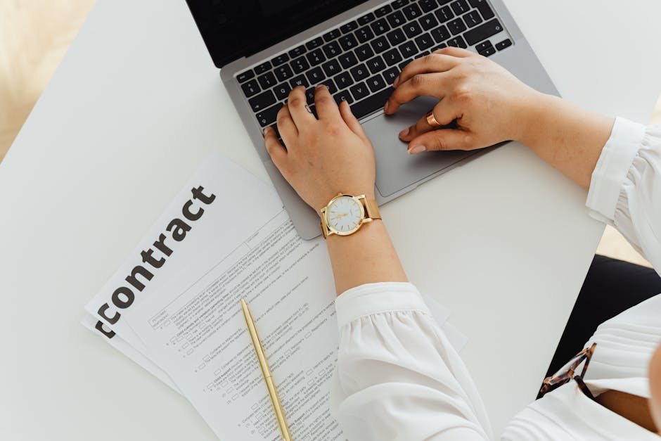 Arabic freelancer signing contract laptop workspace pexels