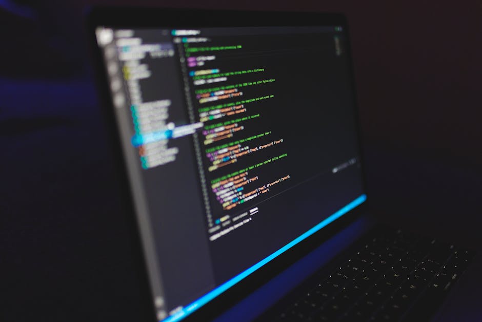 developer working on laptop with colorful Python code terminal