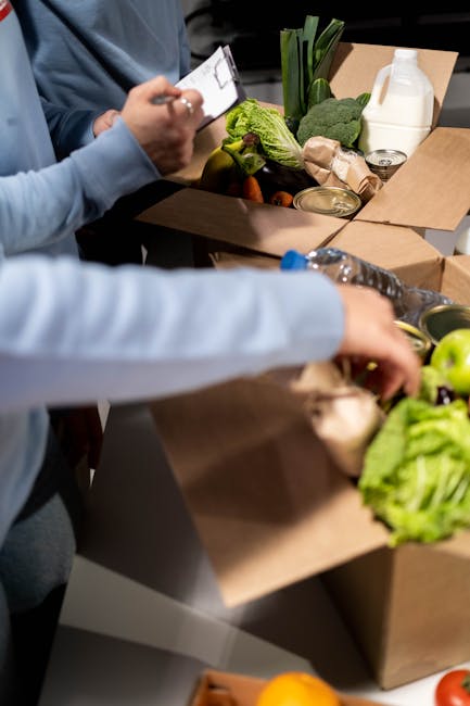 Volunteers organize fresh produce and canned goods for community distribution indoors.