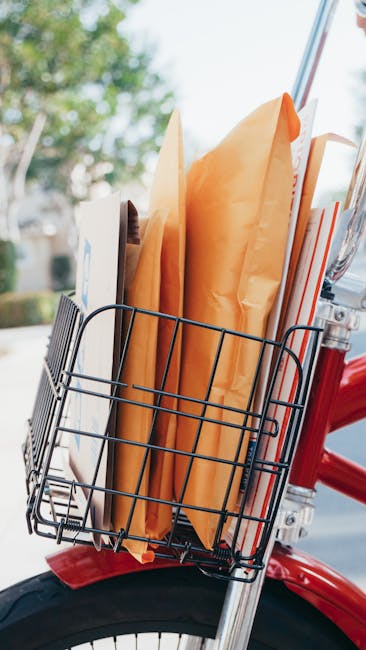 Bicycle with a basket full of packages and envelopes, perfect for delivery services.
