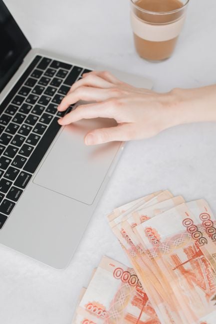 remote freelancer receiving international payment laptop banknotes workspace