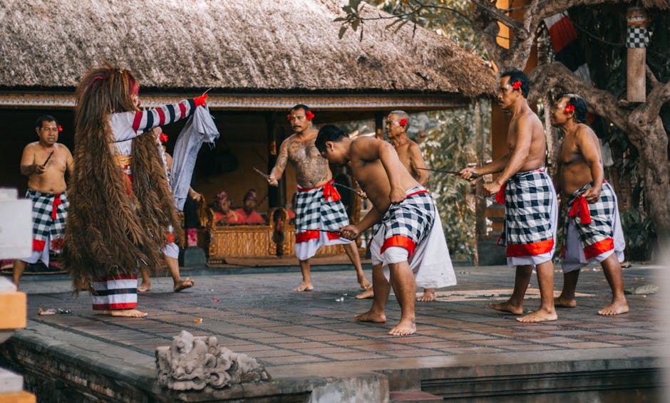 Group of men performing a traditional Balinese dance ceremony in an outdoor setting.