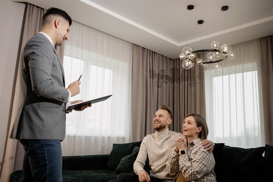 realtor showing apartment plans to clients Abu Dhabi property consultation