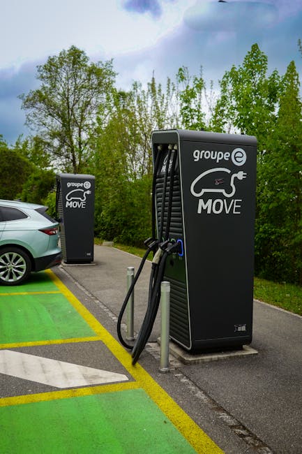Electric vehicle charging station outdoors surrounded by nature, promoting sustainable travel.