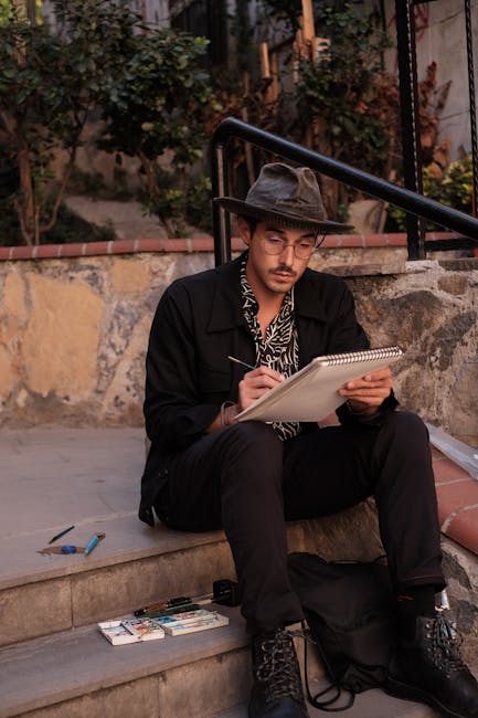 A man sketches on stone steps, capturing creativity and style in an outdoor setting.