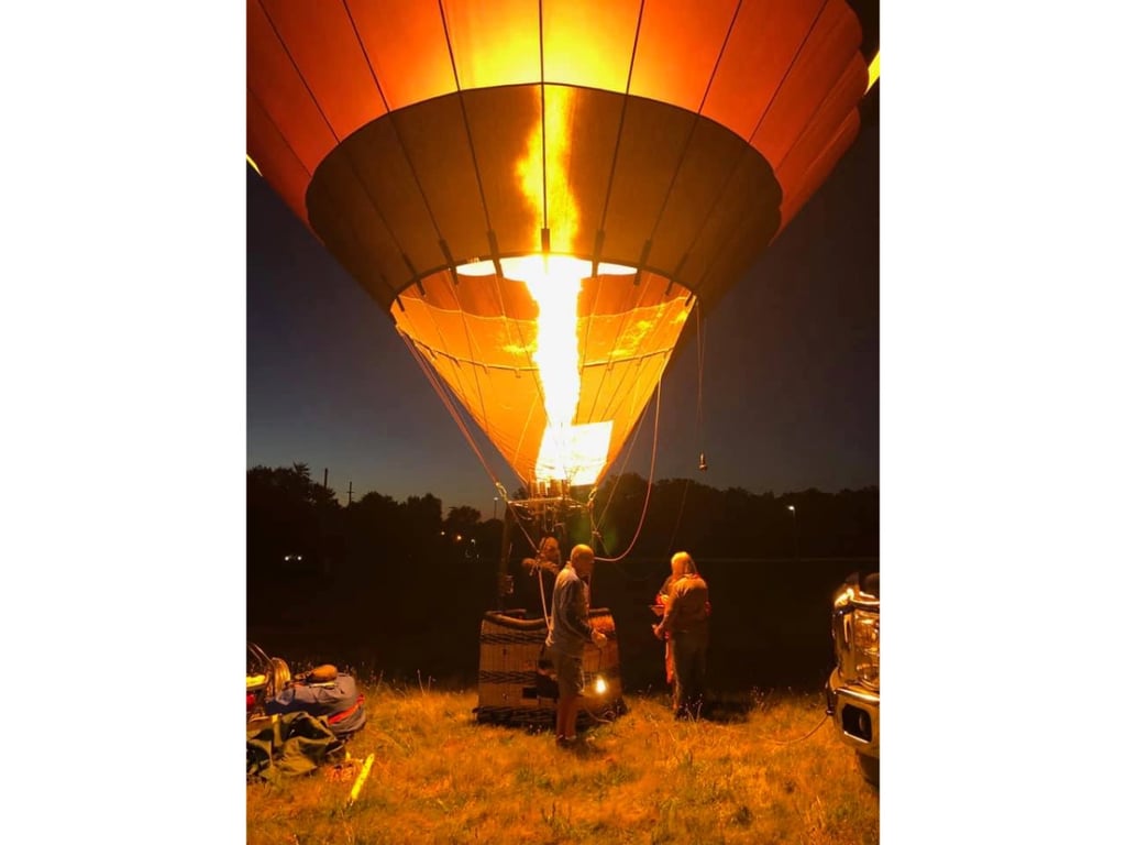 Multiple balloons glowing during the evening event