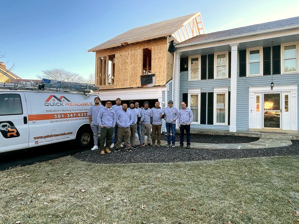 A completed second-story home addition by QuickRemodels with the team and company van out front