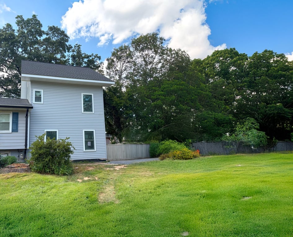 Finished home addition exterior with fresh siding and landscaping in Derwood, Maryland