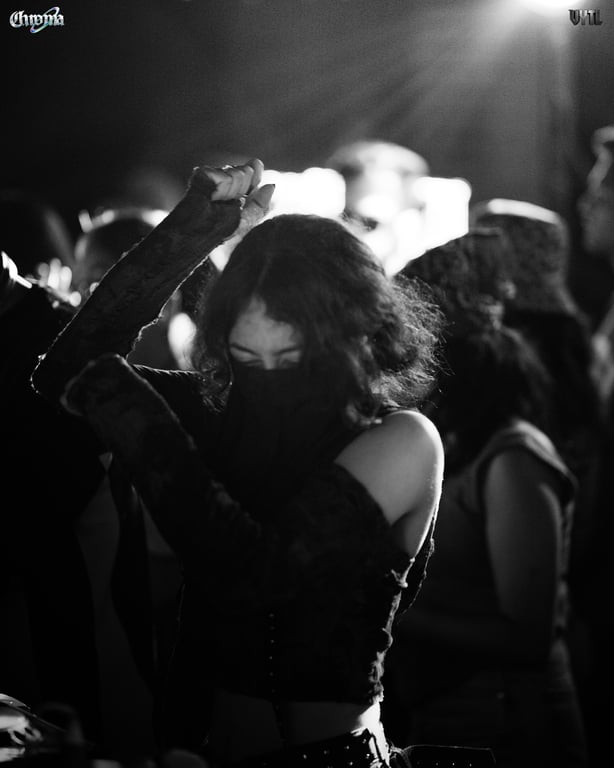 Crowd gathered under the stage lights at night
